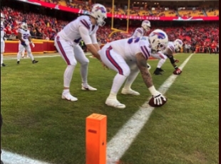 Football players in front of goalpost camera