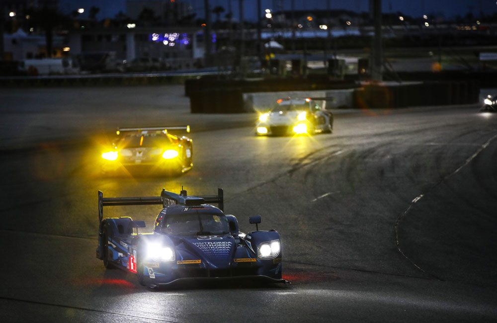 IMSA cars racing at night